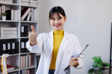 Portrait of happy asian female doctor wearing medical uniform and stethoscope at hospital.Beautiful smiling young asian woman doctor work.
