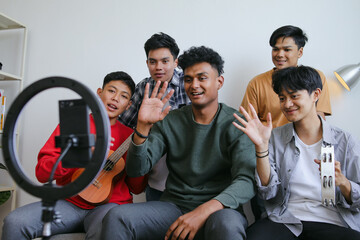 Group Of Diverse People Waving Hand Greeting While Playing Music Together During Online Live Streaming