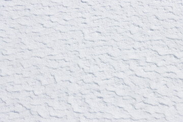 Natural textured pattern on white winter snow surface background