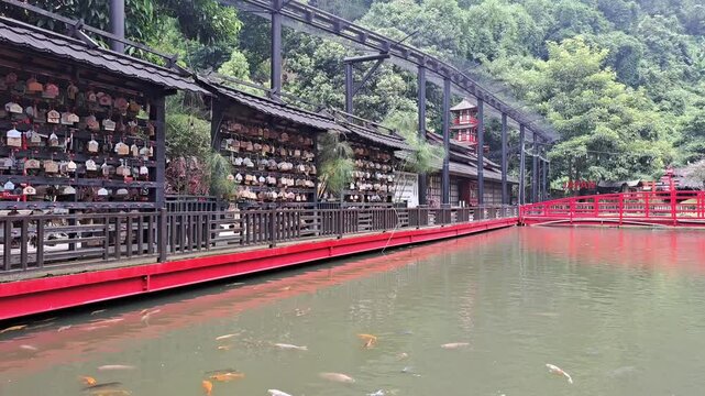 Bandung, indonesia February 28th 2025 : A serene Japanese pond with koi fish and traditional architecture