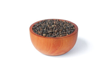 Black peppercorns ( Black pepper ) seeds on wooden bowl isolated on white background. Food...