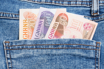Ghanaian Cedi in the pocket of blue jeans