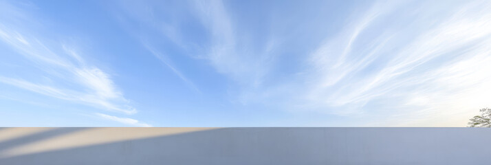 Stunning blue sky with wispy clouds over a serene landscape during late afternoon
