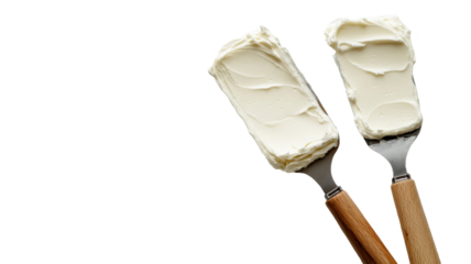 Two spatulas hold creamy frosting, ready for cake decorating.  Perfect for baking blogs or recipe websites!