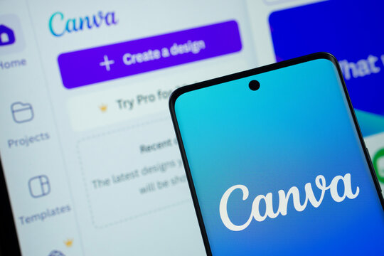 Dhaka, Bangladesh- 05 March 2025: Canva logo is displayed on a smartphone screen, with the canva website visible on a computer screen in the background.