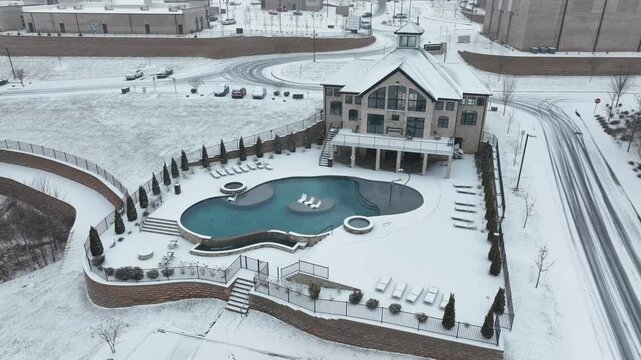 Luxury apartment houses with community swimming pool during snowy winter day in USA. Aerial view. Modern housing area in suburb. Lynchburg, Virginia.