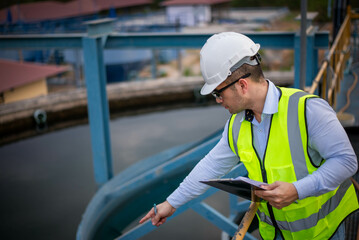 A professional plumbing engineer is checking a water filtration system at a factory to ensure that...