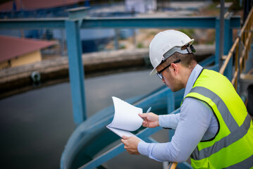 A professional plumbing engineer is checking a water filtration system at a factory to ensure that...