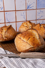 Crossed bread from wheat and rye flour on the sourdough. Bread on the sourdough. Homemade Crusty Bread in a Cozy Rustic Kitchen