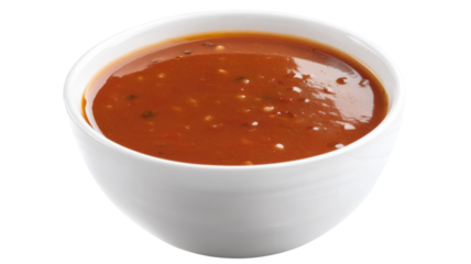 White bowl full of tomato soup with herbs on transparent background