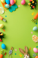 Easter vertical background. Frame border of Colorful painted Easter eggs, bunny, festive decoration, on vibrant green background. Easter banner design, poster template. Top view.