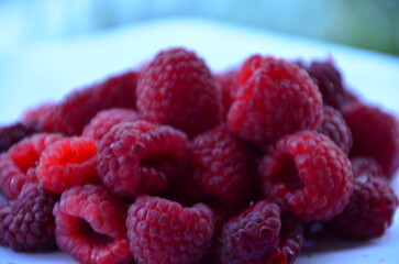 Raspberry. Sweet red raspberries. Juicy raspberries on the table. Fresh Raspberries. Rubus idaeus. Sweet healthy dessert. Fruit dessert.