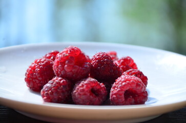 Raspberry. Sweet red raspberries. Juicy raspberries on the table. Fresh Raspberries. Rubus idaeus. Sweet healthy dessert. Fruit dessert.