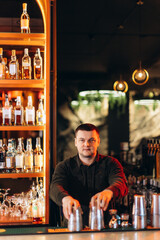 Bartender Performing at Elegant Bar with Shelves of Liquors Under Dim Lighting