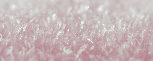 Capturing delicate ice crystals glistening in soft pink hues, creating a stunning winter wonderland...