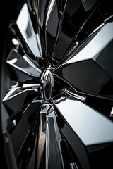 Close-up of shiny metallic car wheel with geometric design