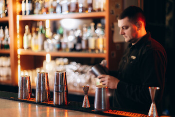 Bartender Preparing Cocktails at Modern Bar Inside a Stylish Nightclub Setting