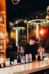 Bartender Preparing Drinks at a Stylish Modern Bar Counter
