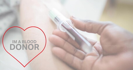 Image of im a blood donor text over hand of diverse doctor and arm of patient giving blood