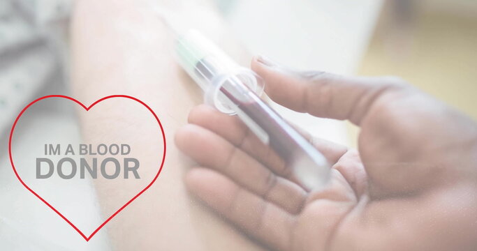 Image of im a blood donor text over hand of diverse doctor and arm of patient giving blood