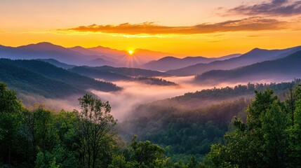 Obraz premium A majestic sunrise view of a mountain landscape, with golden light brightening the peaks and mist drifting gently through the valleys