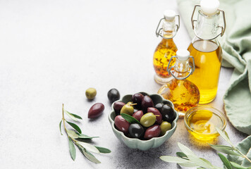 Assorted olives and olive oil on rustic table