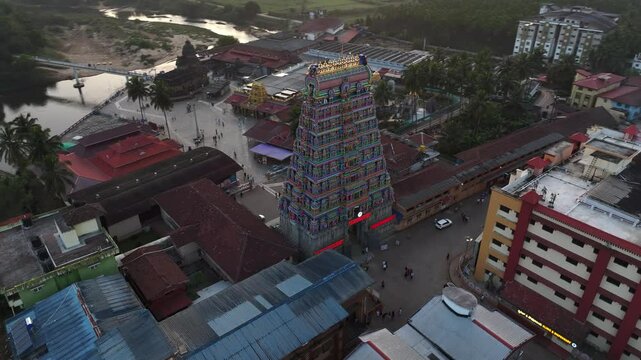 Aerial view of Sringeri Sharada Temple, located in the Chikkamagaluru district of Karnataka, India, alongside the serene Tunga River at sunset.