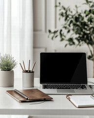 Fototapeta premium Serene Workspace Setup: An inviting workspace with a laptop, notebooks, and greenery create a comfortable environment. Ideal for creative professionals
