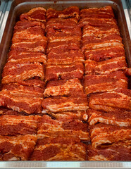 Marinated pork's belly on a tray ready for cooking.