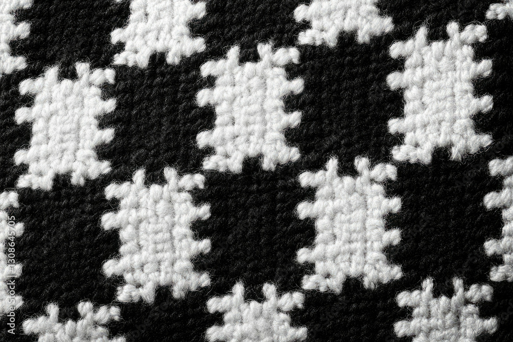 Poster close-up of a black and white houndstooth pattern woven fabric texture.