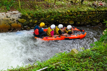 Group Enjoying a Fun River Rafting Adventure in Lush Green Environment