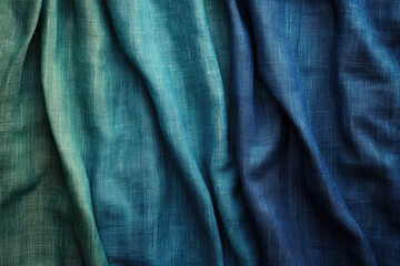 Fototapeta premium Textured fabric in shades of teal and blue, showing gradient effect and draped folds.