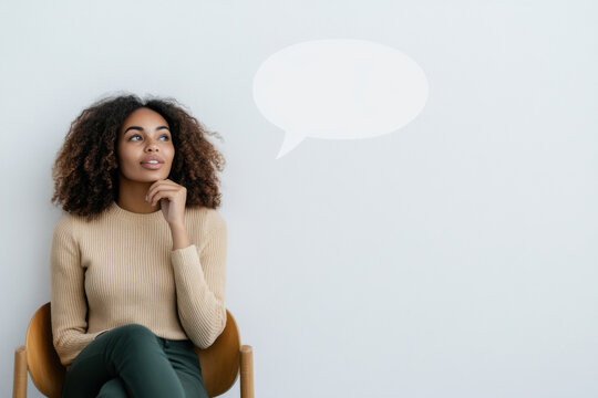 Young woman thinking with empty speech bubble above her head