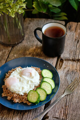 Bowl with buckwheat, fried egg and cucumber