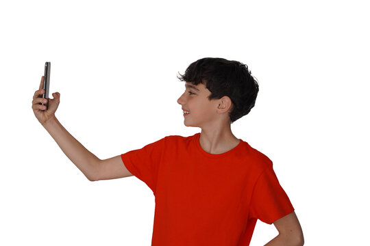 png, transparent background, isolated preteen boy with freckles in profile taking a selfie with a smartphone, with red t-shirt