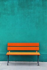 Orange bench against teal wall