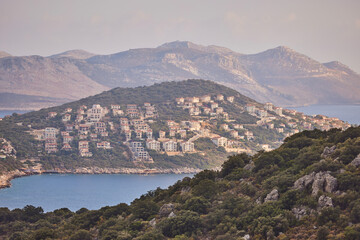 Obraz premium View of the area of the city of Kas in Turkey, located on the peninsula and the Greek island of Kastellorizo in the distance