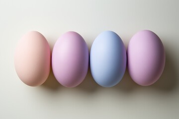 Four pastel-colored eggs aligned on white background