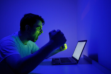 Anger and Frustration of a Man Working Late at Night on a Laptop