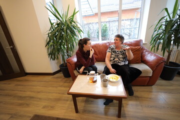 Grandmother and a daughter talking indoors