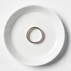Polished silver ring on white dish, elegance and simplicity