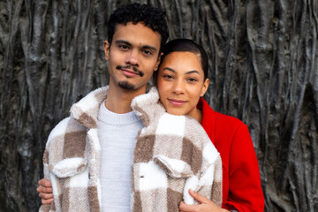 Young couple embracing, showing love and affection outdoors