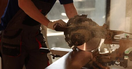 A skilled carpenter operates a precision miter saw, expertly showcasing their craftsmanship in the art of woodworking