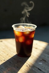 Refreshing Iced Coffee in a Plastic Cup on a Sunny Wooden Table