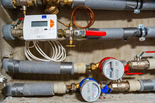 Smart water and heat meters with remote data transmission installed in a European utility system. The concept represents modern energy efficiency and digital infrastructure development