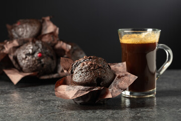 Dark chocolate muffins and cup of black coffee.