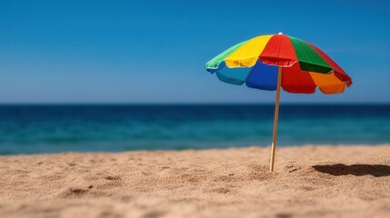 Colorful Beach Umbrella on Sandy Shore with Tranquil Ocean Background