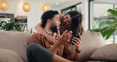 Happy couple hug, talking and mobile in home for wow, online shopping or surprise purchase for sale. Man, woman and typing on phone on sofa to relax for streaming service, social media or show video - Powered by Adobe