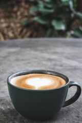 Latte art coffee cup on wooden table
