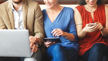 People using digital devices: laptop, tablet, smartphone. Diverse man and women using digital devices. Technology and connectivity in everyday life. Connection and technology. Businessman and women